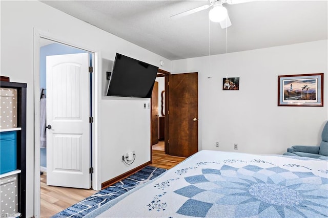 bedroom featuring wood finished floors and a ceiling fan