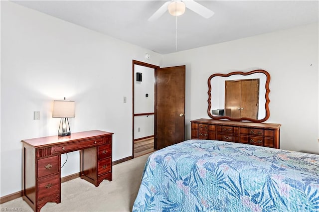 carpeted bedroom featuring a ceiling fan and baseboards