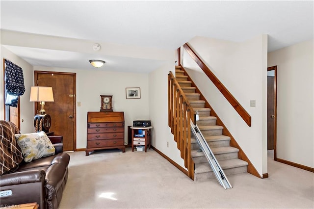 living room featuring stairway, light colored carpet, and baseboards