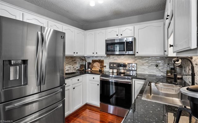 kitchen with appliances with stainless steel finishes and white cabinetry