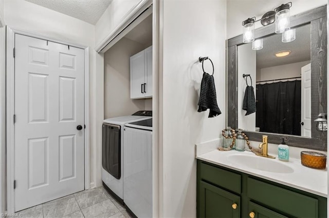 full bathroom with tile patterned floors, separate washer and dryer, vanity, and a textured ceiling