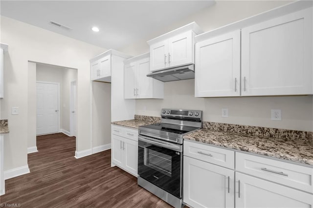 kitchen featuring under cabinet range hood, stainless steel electric stove, white cabinetry, dark wood-type flooring, and visible vents