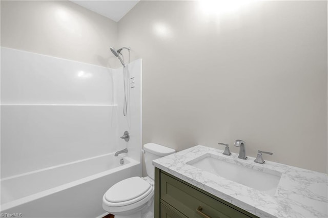 bathroom with shower / washtub combination, toilet, and vanity