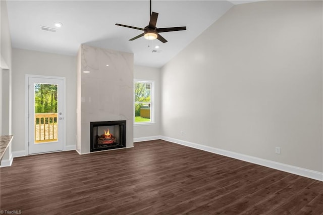unfurnished living room featuring lofted ceiling, visible vents, a ceiling fan, and plenty of natural light