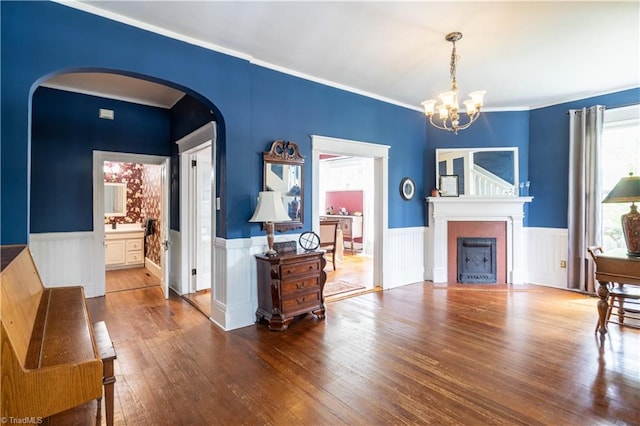 living area with hardwood / wood-style floors and an inviting chandelier