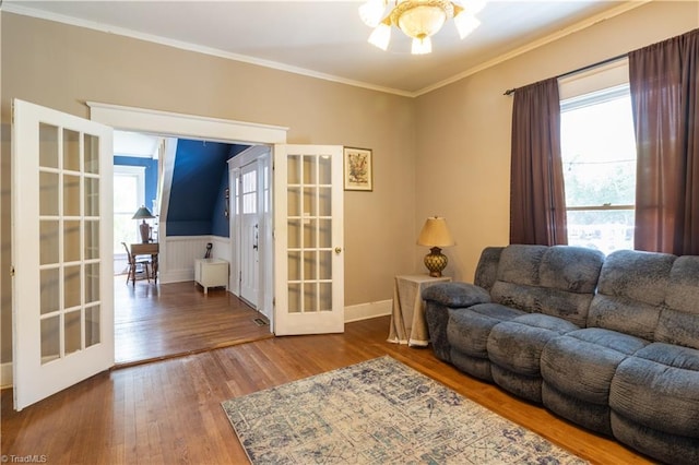 living room with ornamental molding, french doors, and hardwood / wood-style floors