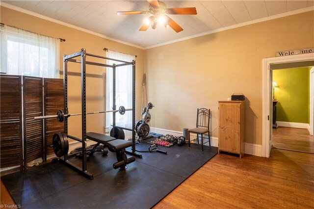 exercise room with ceiling fan, hardwood / wood-style floors, and ornamental molding