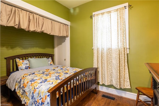 bedroom with dark wood-type flooring