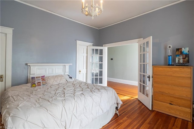 bedroom featuring a chandelier, ornamental molding, french doors, and hardwood / wood-style floors