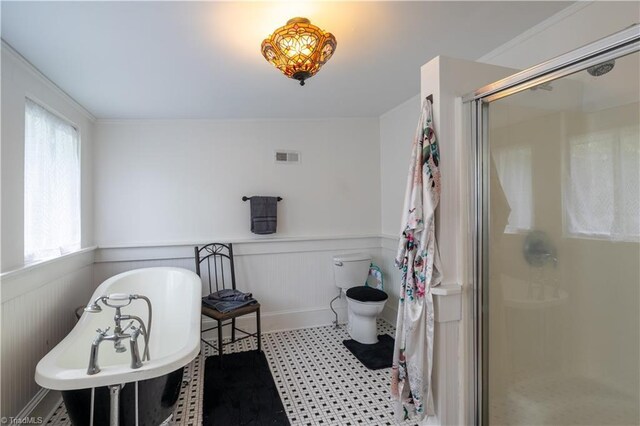 bathroom featuring walk in shower, tile patterned flooring, and toilet