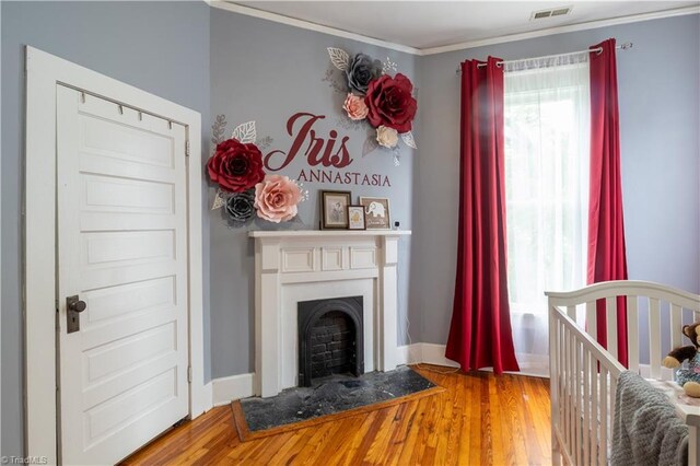 living room featuring ornamental molding and wood-type flooring