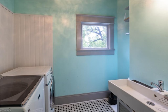 bathroom featuring sink, tile patterned flooring, and washing machine and clothes dryer