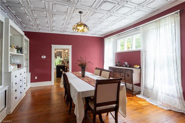 dining space featuring hardwood / wood-style floors and coffered ceiling