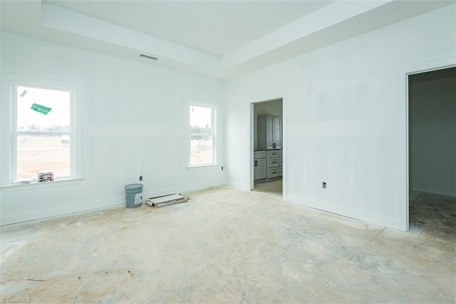 unfurnished room with a tray ceiling