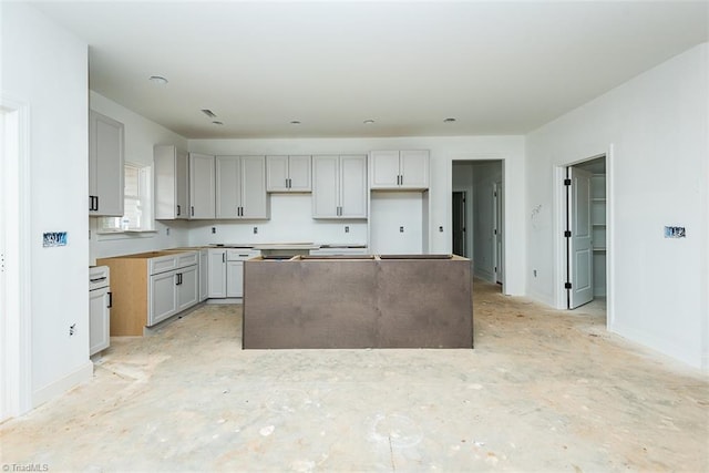 kitchen with gray cabinets and a center island