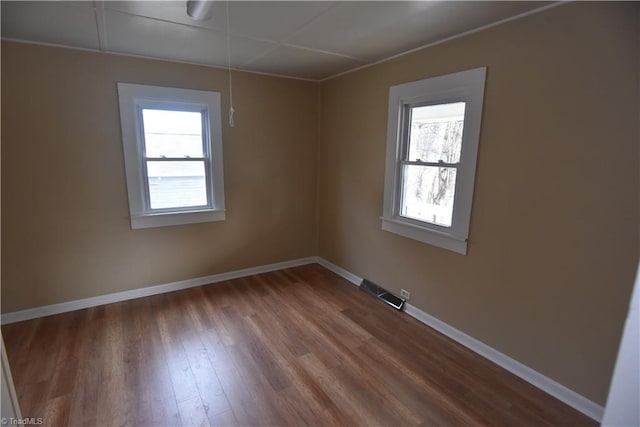 spare room with wood-type flooring