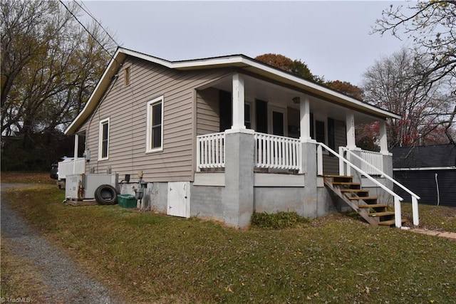 view of front of house with a porch and a front yard