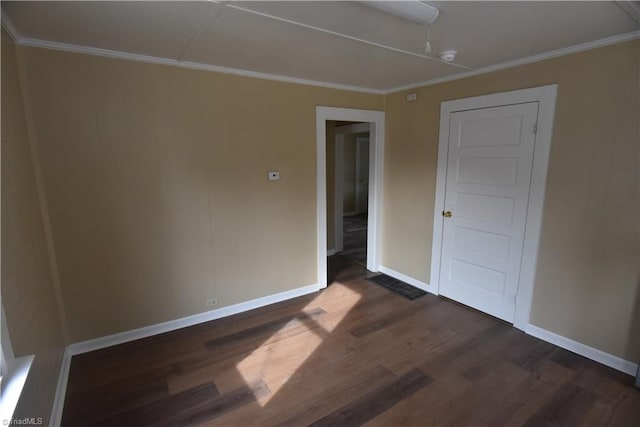 spare room featuring dark hardwood / wood-style flooring and ornamental molding