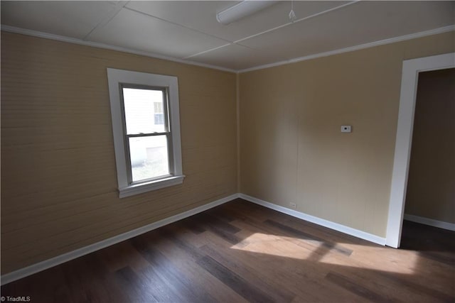 empty room featuring dark hardwood / wood-style floors and ornamental molding