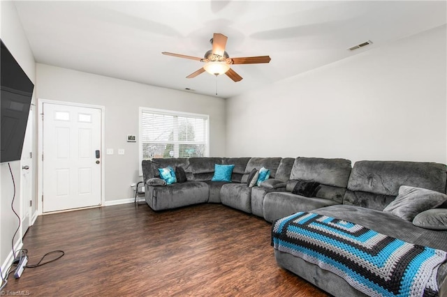 living room with ceiling fan and dark hardwood / wood-style flooring