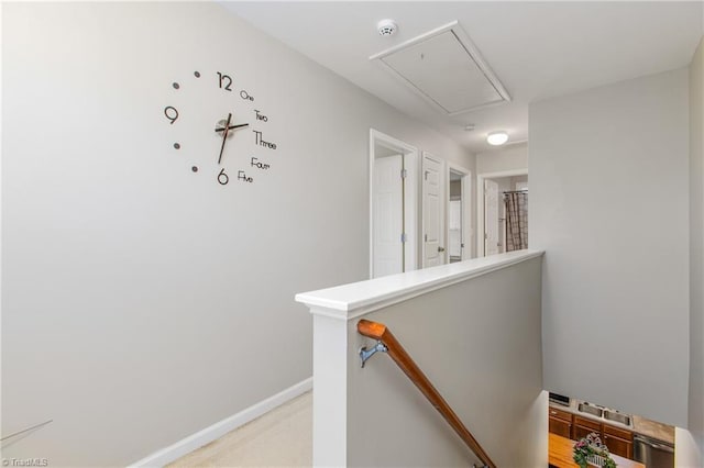 hallway featuring light colored carpet