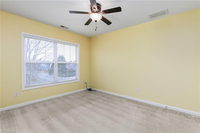 unfurnished room with light carpet and ceiling fan