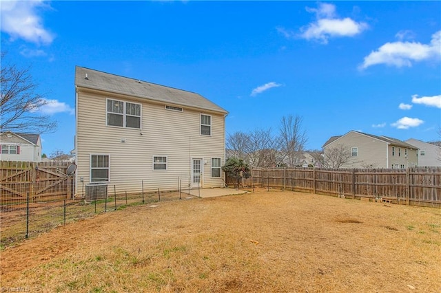 rear view of house featuring a patio and central AC