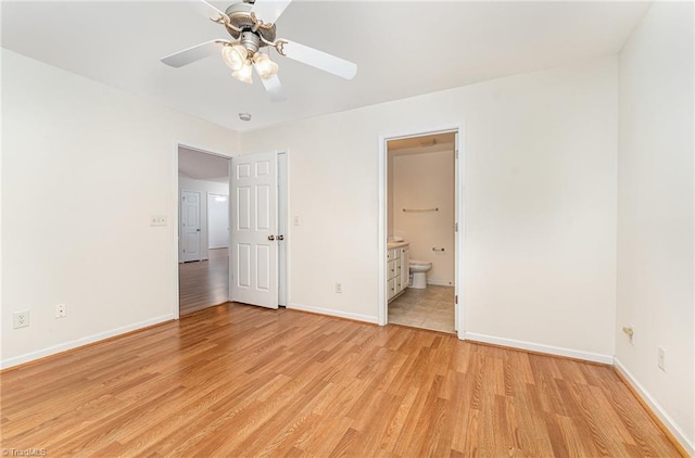 unfurnished bedroom featuring baseboards, ceiling fan, ensuite bathroom, and light wood-type flooring