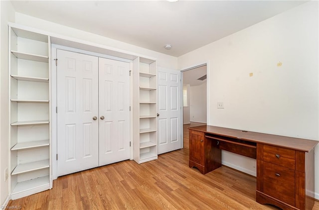 unfurnished office featuring light wood finished floors