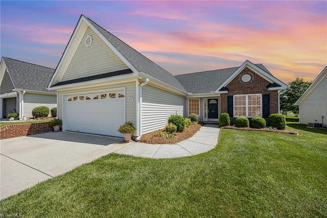view of front of property featuring driveway, a front yard, a garage, central AC, and a shingled roof