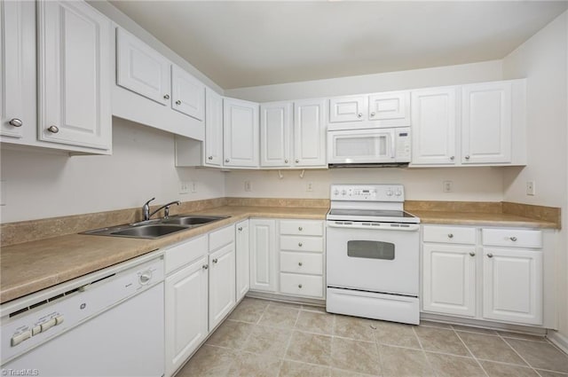 kitchen featuring a sink, white cabinets, white appliances, and light countertops