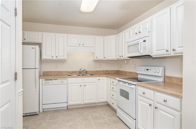 kitchen featuring white appliances, white cabinetry, a sink, and light countertops