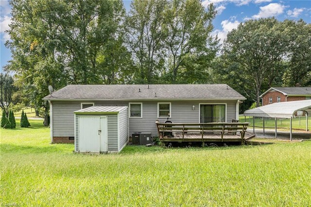 back of house featuring a storage unit, central air condition unit, a yard, a carport, and a deck