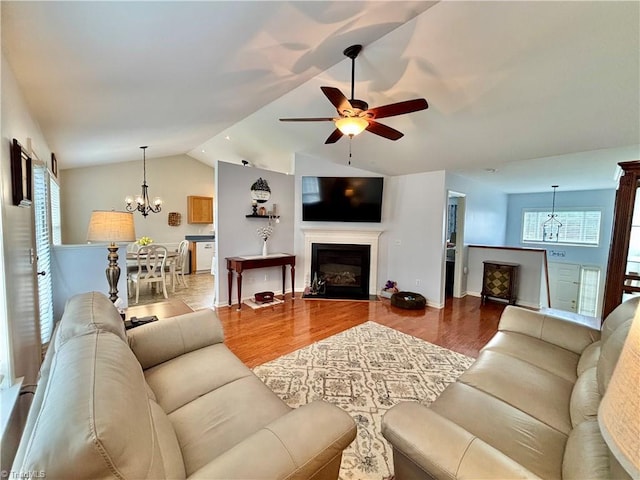 266 Sailway Rd, Winston-Salem, NC 27127 - living area with a chandelier, a ceiling fan, lofted ceiling, wood finished floors, and a glass covered fireplace