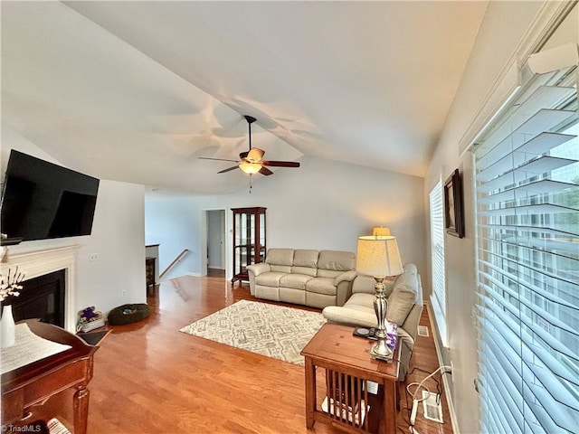 266 Sailway Rd, Winston-Salem, NC 27127 - living area with lofted ceiling, a ceiling fan, wood finished floors, and a glass covered fireplace