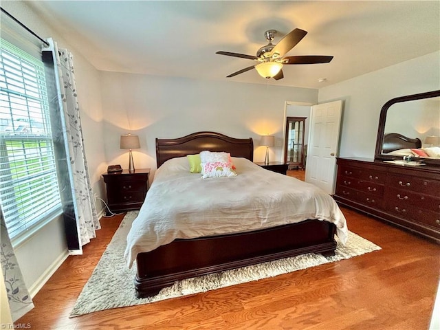 266 Sailway Rd, Winston-Salem, NC 27127 - bedroom with multiple windows, ceiling fan, wood finished floors, and baseboards