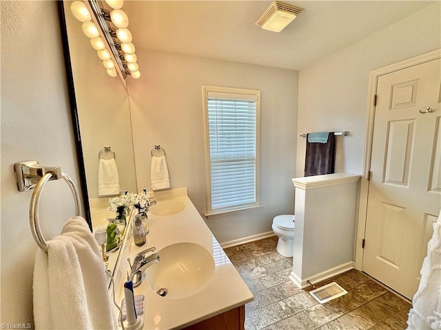 266 Sailway Rd, Winston-Salem, NC 27127 - bathroom with double vanity, toilet, and baseboards