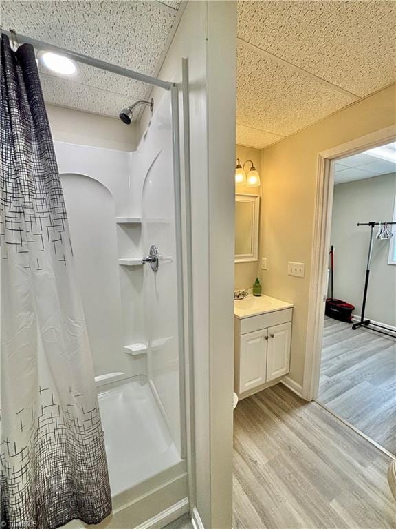 266 Sailway Rd, Winston-Salem, NC 27127 - full bath featuring a stall shower, wood finished floors, vanity, a paneled ceiling, and baseboards