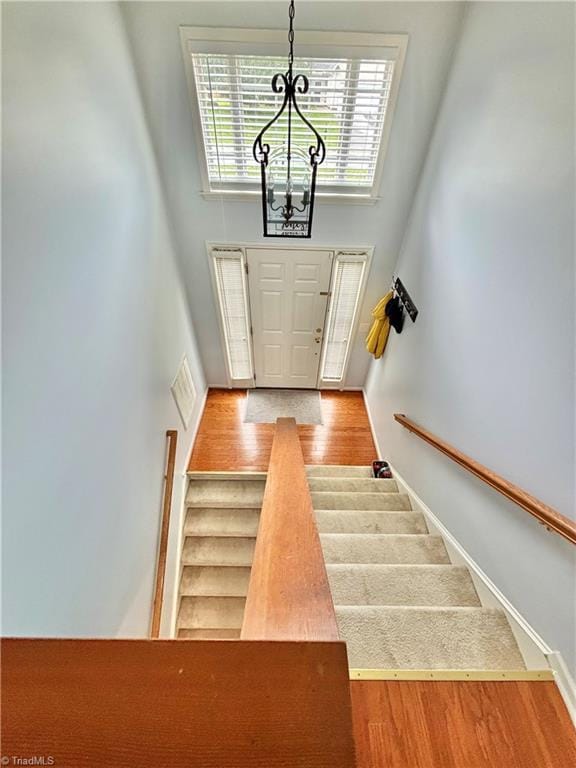 266 Sailway Rd, Winston-Salem, NC 27127 - staircase featuring a chandelier, a high ceiling, wood finished floors, and baseboards