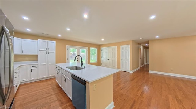 2209 Bracyridge Rd, Greensboro, NC 27407 - kitchen with dishwasher, a sink, stainless steel refrigerator, an island with sink, and recessed lighting