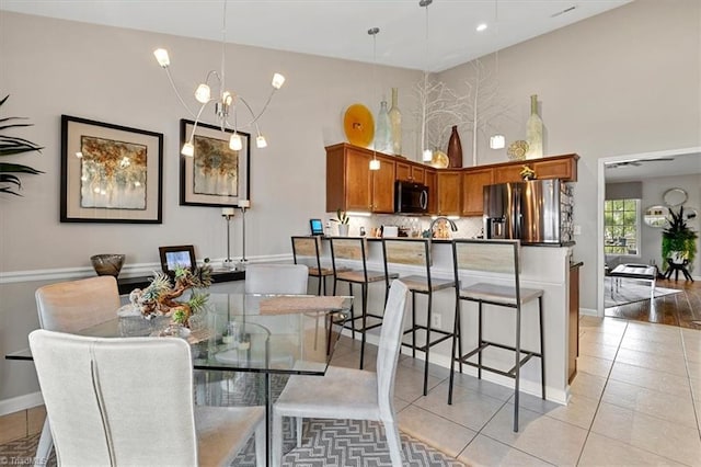 dining room featuring light hardwood / wood-style flooring and a notable chandelier