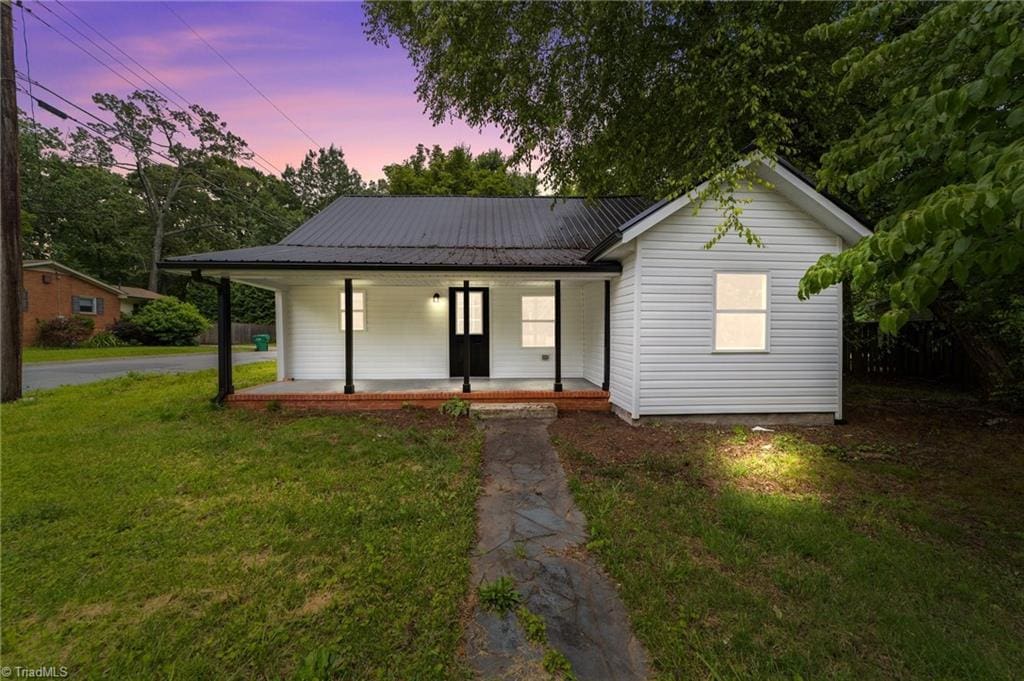 301 Rockspring Rd, High Point, NC 27262 - view of front of house with a porch, a lawn, and a metal roof
