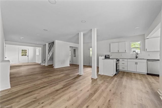 301 Rockspring Rd, High Point, NC 27262 - kitchen featuring stainless steel appliances, open floor plan, white cabinets, light wood-style flooring, and backsplash