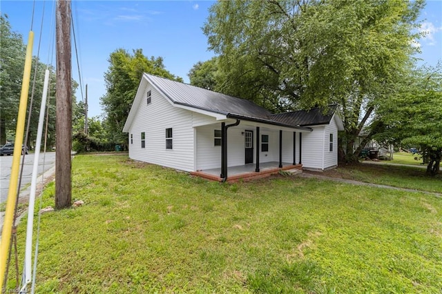 301 Rockspring Rd, High Point, NC 27262 - view of front of home with a front yard, a metal roof, and a patio area