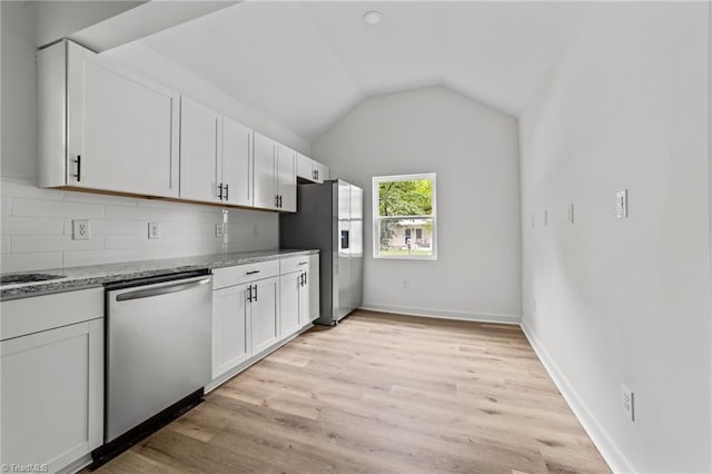 301 Rockspring Rd, High Point, NC 27262 - kitchen featuring stainless steel appliances, white cabinetry, light stone counters, backsplash, and vaulted ceiling