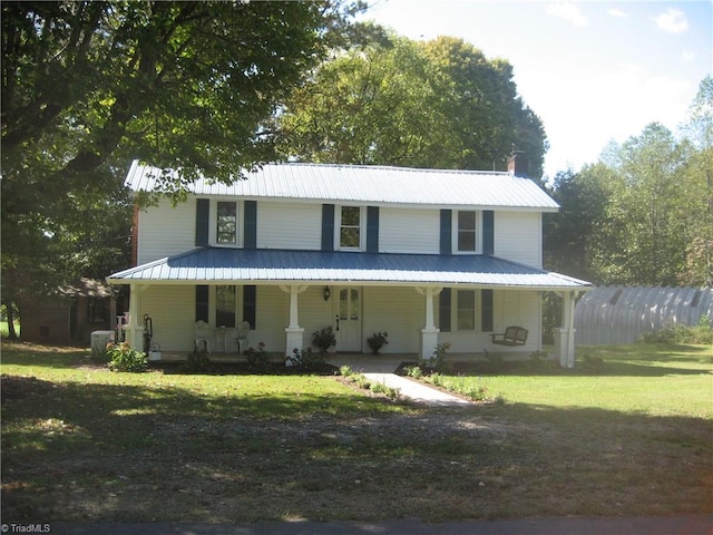 farmhouse with a porch and a front yard