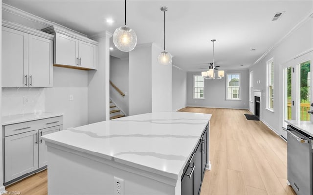 700 Fairmile Dr, Greensboro, NC 27455 - kitchen with dishwasher, crown molding, a kitchen island, light wood finished floors, and tasteful backsplash