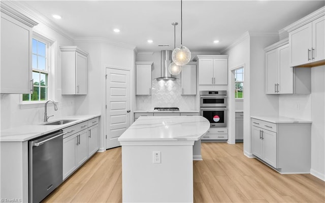 700 Fairmile Dr, Greensboro, NC 27455 - kitchen with stainless steel appliances, wall chimney range hood, a sink, light wood-style flooring, and crown molding