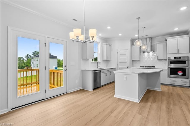 700 Fairmile Dr, Greensboro, NC 27455 - kitchen featuring wall chimney exhaust hood, stainless steel appliances, light countertops, crown molding, and backsplash