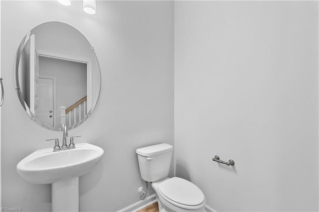 700 Fairmile Dr, Greensboro, NC 27455 - bathroom featuring toilet, baseboards, and wood finished floors